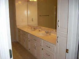 Master bath with double vanity and extra cabinetry.