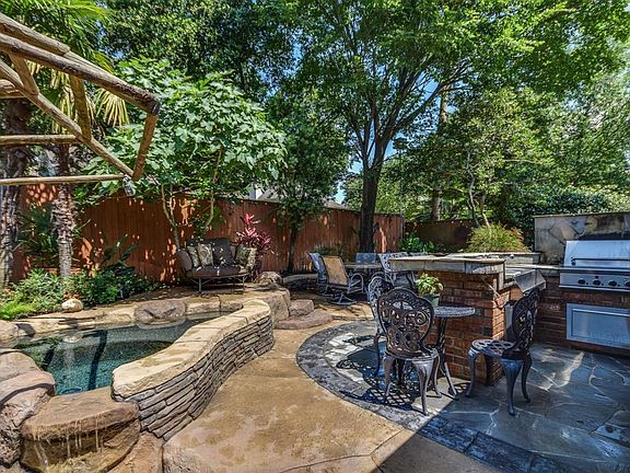 Outdoor kitchen with multi level seating areas.
