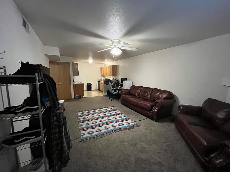Livingroom has a gas firepalce connected to kitchen