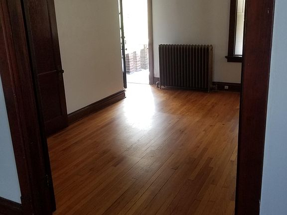 View from living room looking through bedroom to front balcony.