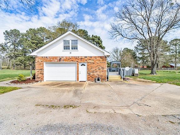 View of side loading garage with multiple parking spaces