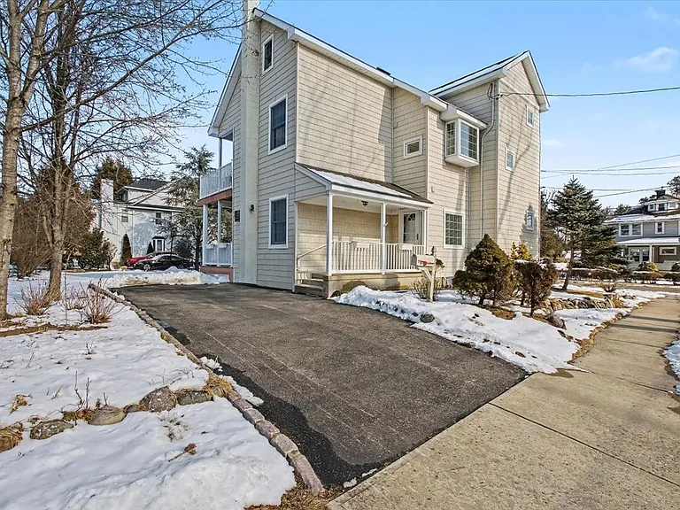 Side of home with driveway & entrance to apt.