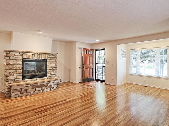 West Facing Entrance/Windows Living Room W Stone Fireplace.