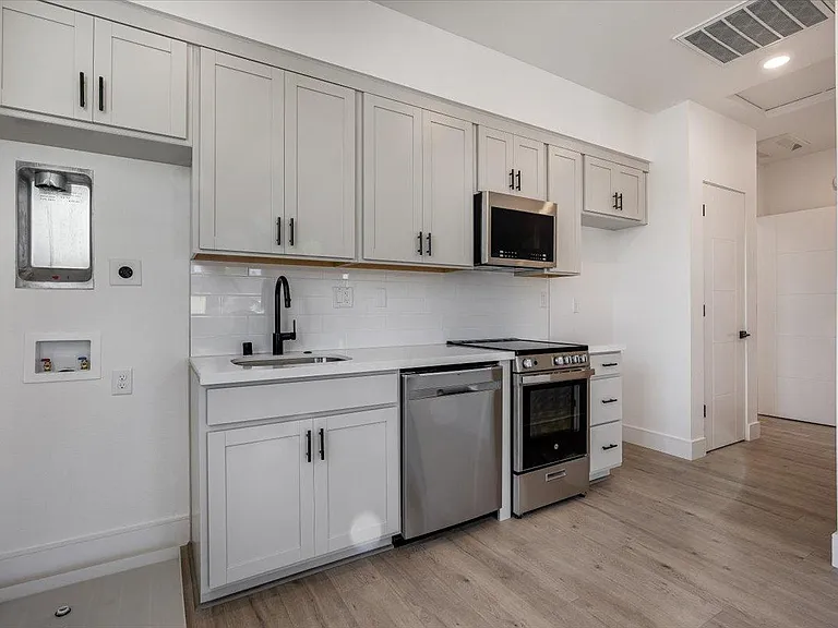 Stackable washer/dryer and refrigerator are included just weren't installed yet when photos were taken.