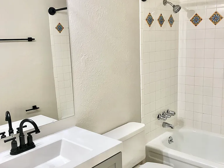 Explore this chic bathroom, featuring a modern vanity and delightful tile details. Explore this chic bathroom, featuring a modern vanity and delightful tile details.
