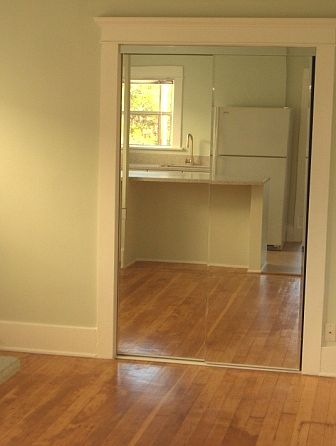 Main room (with kitchen reflection in mirrored closet door)