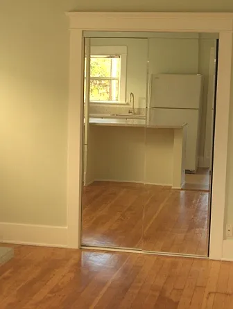 Main room (with kitchen reflection in mirrored closet door)