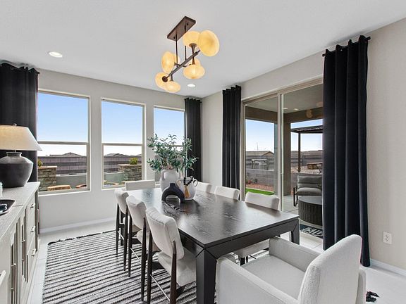 The well-lit cafe features a tray ceiling with decorative accents and access to the backyard and cov