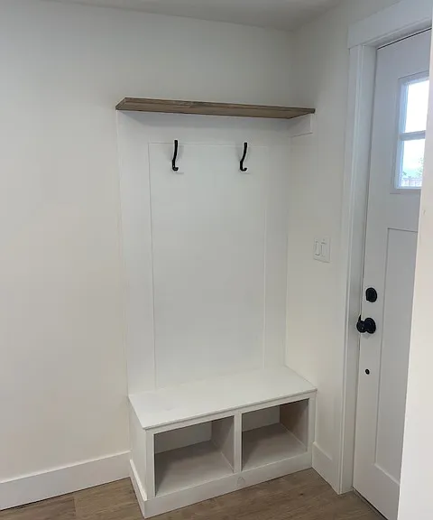 Custom built bench/cubbies and coat/back pack hanging off the entry