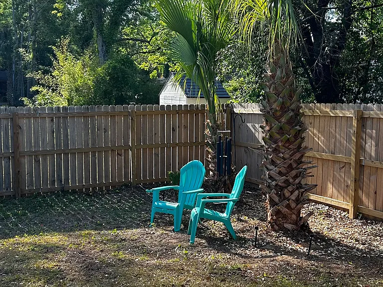 View of fenced backyard from owners suite accessible through sliding glass doors