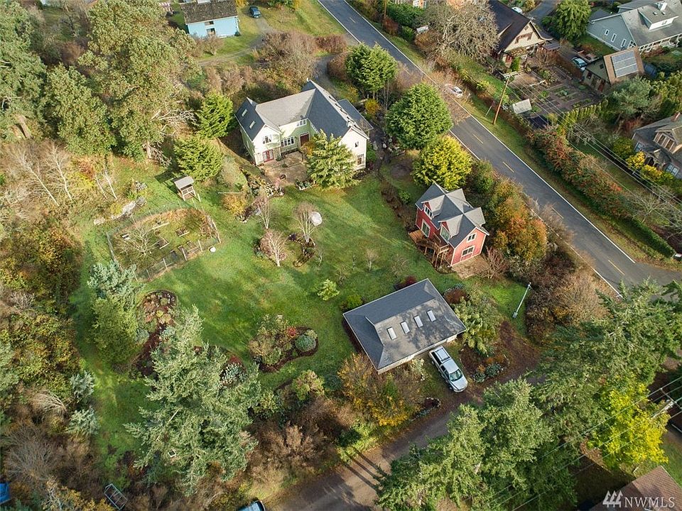 Estate sized property is a full city block with the main house, 960 sq ft. studio/ADU and 864 sq ft. shop taking the East 4 lots.  Possibility of three additional building sites to the West(left).