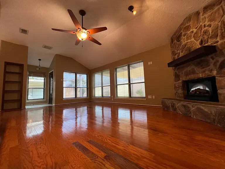Living room with natural light surrounded with big windows.