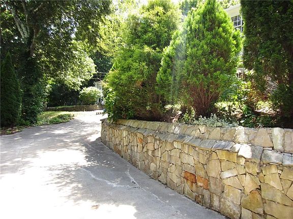 This is the Main Driveway on the Left that Leads to the 2 Car Garage! Beautiful Stone Work!