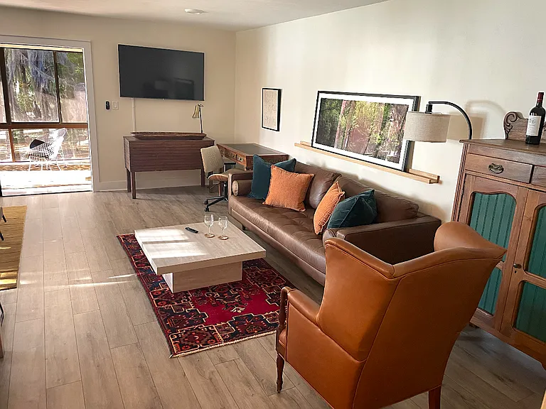 Open plan layout, including TV, work area & sunroom