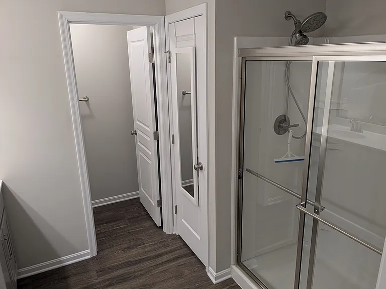 Master bathroom with large linen closet and separate area for toilet.