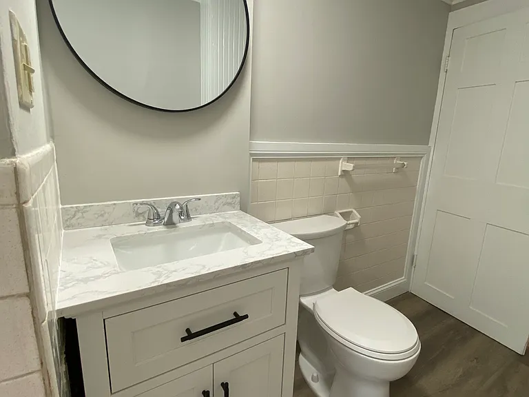 Mirror, vanity and toilet shown taken unit was vacant.