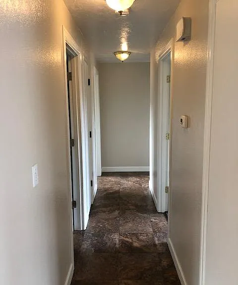 turning right down the hallway. The first door on the right and the second door on the left are linen closets