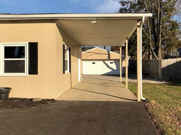 Carport with detached garage