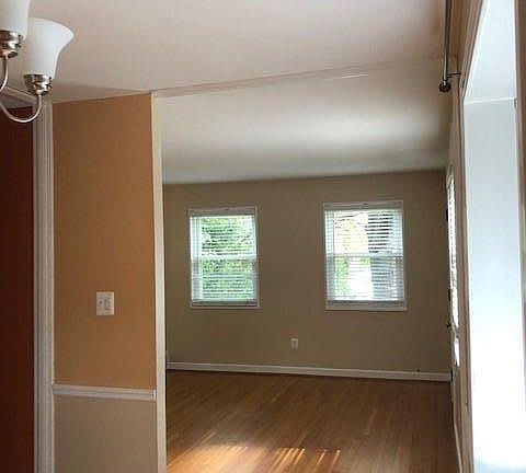 Picture taken in the dining room with bay window, looking into the living room