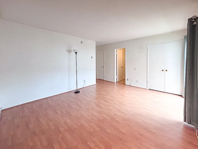 Another angle of master bedroom suite showing doors to private bathroom and 2 closets