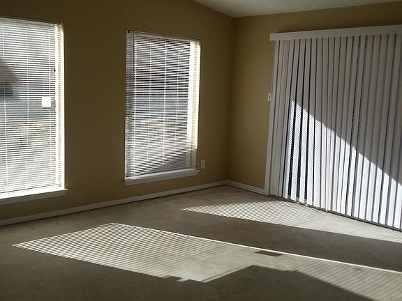 Living room with concrete floor and vaulted ceiling.
