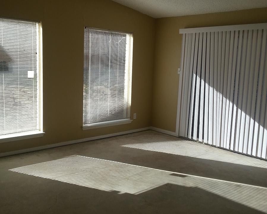 Living room with concrete floor and vaulted ceiling.