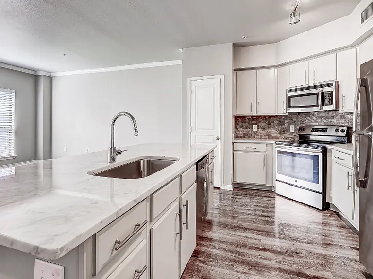 Kitchen with pantry, garbage disposal, and modern track lighting