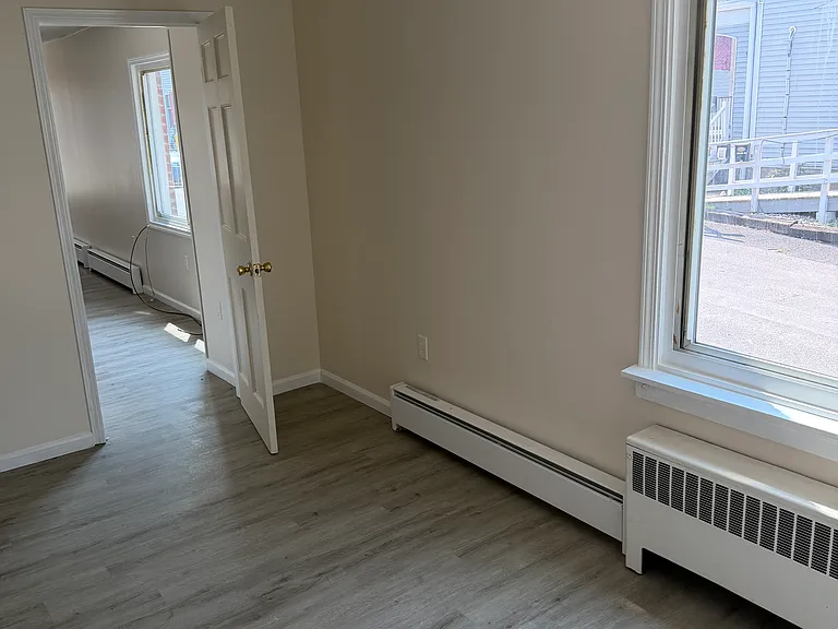 Bedroom, with view of windows looking out onto quiet side street