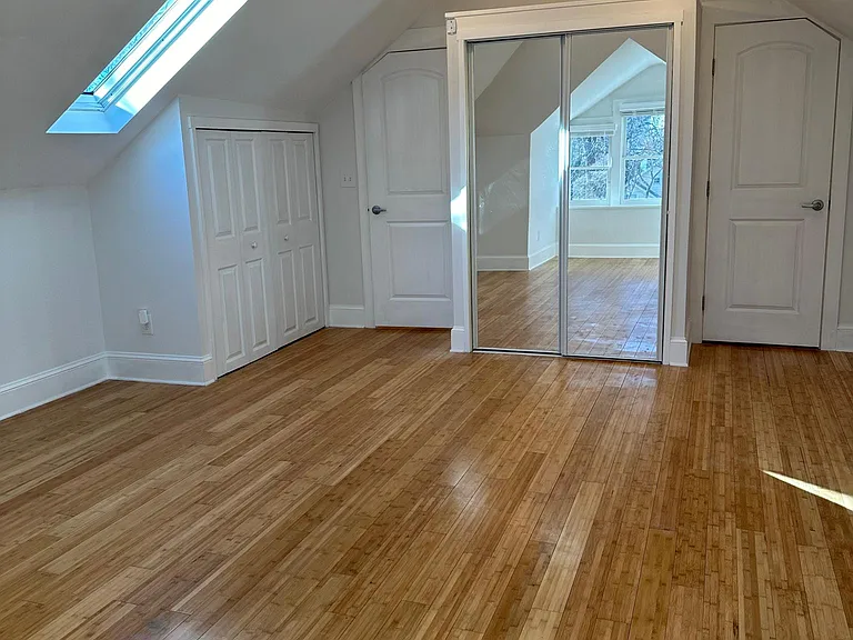 Bedroom view showing laundry room door and bathroom door