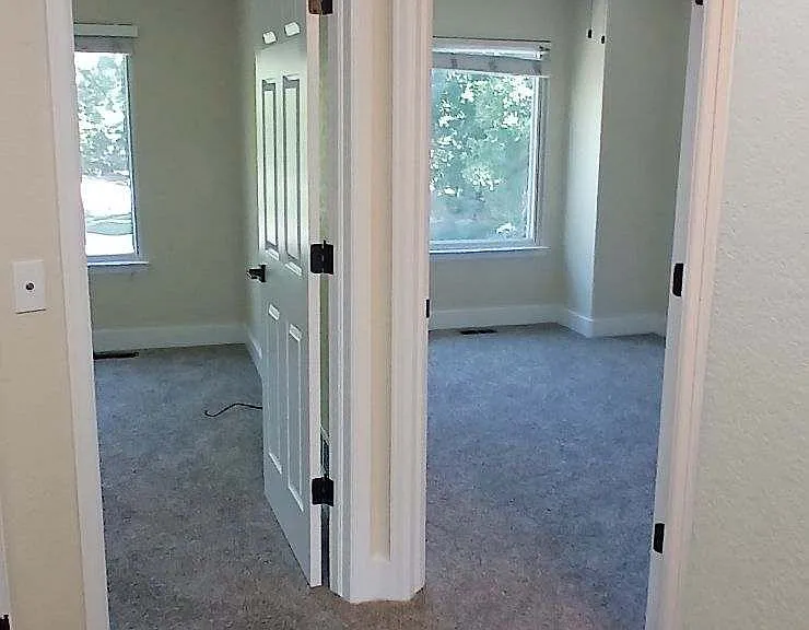 Side by side bedrooms with ceiling fans.