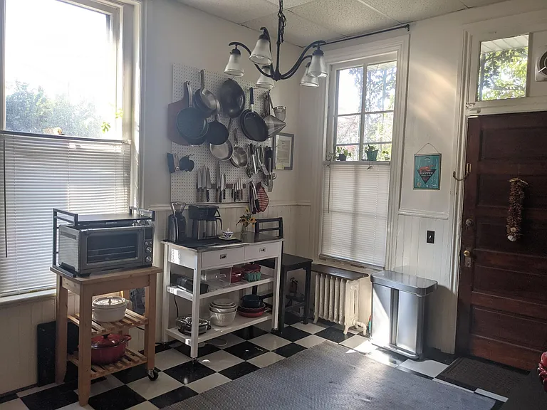 Kitchen/dining area with bright afternoon light.