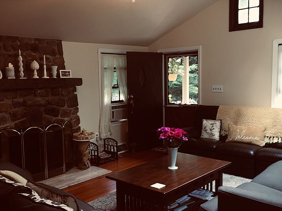 Living Room fully furnished with skylights and seasonal lakeview.