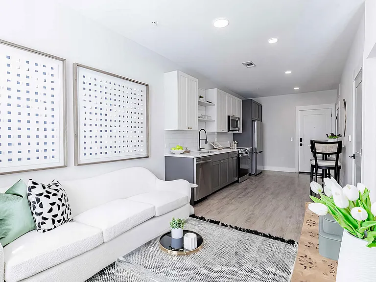 Cozy open floor plan with laminate wood floors and modern appliances
