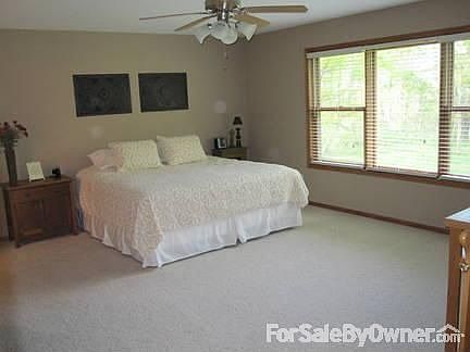 Master Bedroom : Walk-in closet and attached master bath. Large windows overlooking the woods.