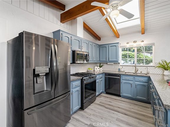 Kitchen with top appliances, skylight, granite counters