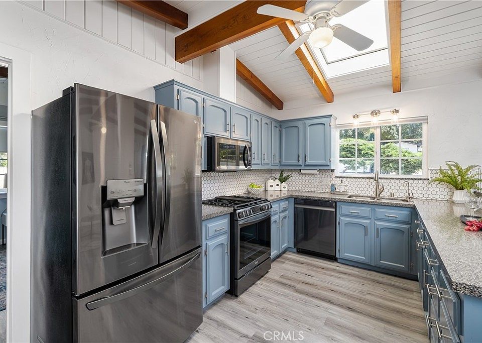 Kitchen with top appliances, skylight, granite counters
