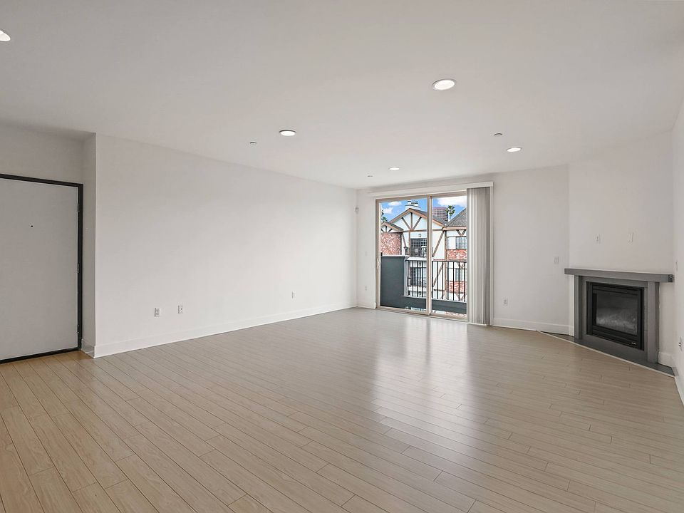 Spacious Living Room with Electric Fireplace and Patio Access