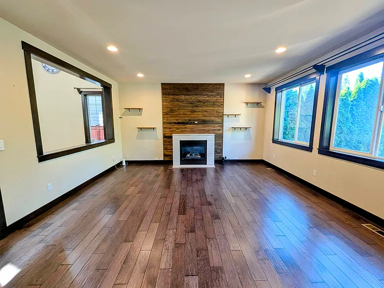 Great room with gas fire place and wood paneling.
