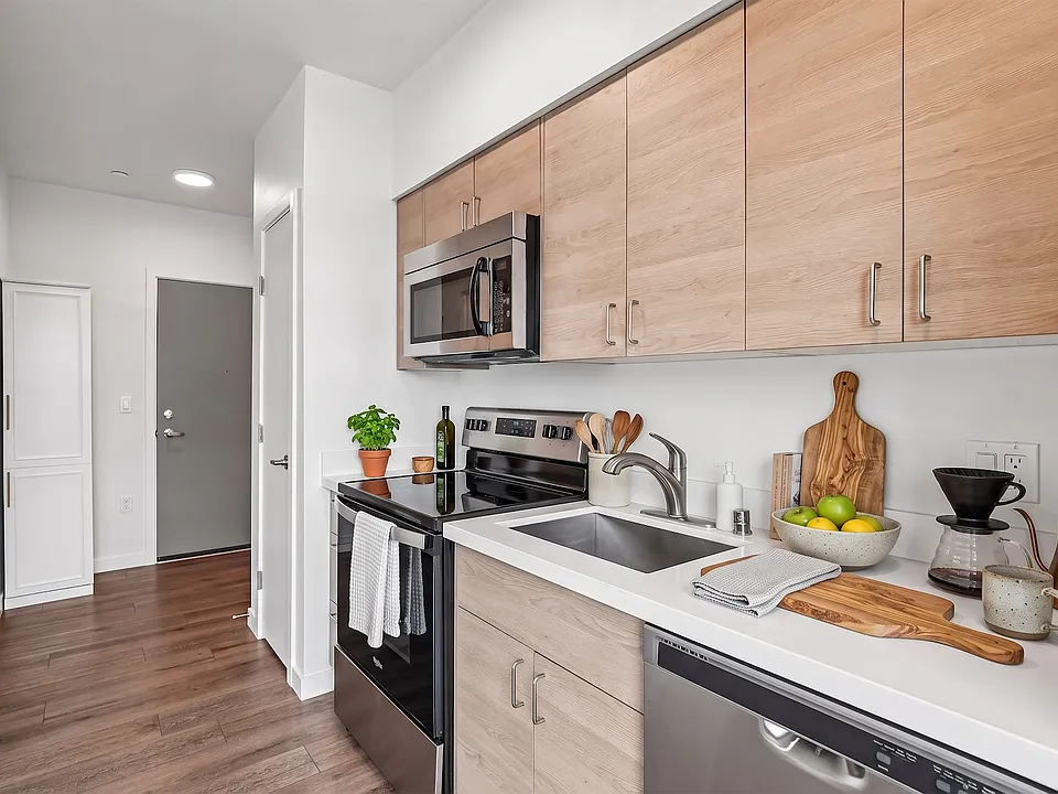 Modern kitchen with generous cabinet storage and a full stainless steel appliance package.
