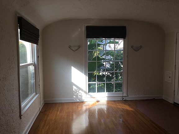 SUNNY LIVING ROOM WITH HARDWOOD FLOORS.