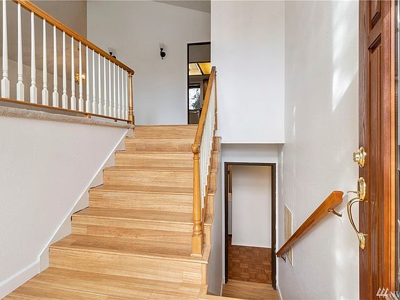 Open entry with laminate wood floor, high ceiling and more!