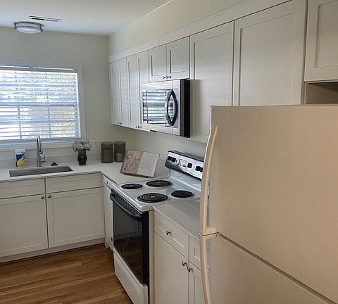 New kitchen cabinets with quartz counters & installed microwave.