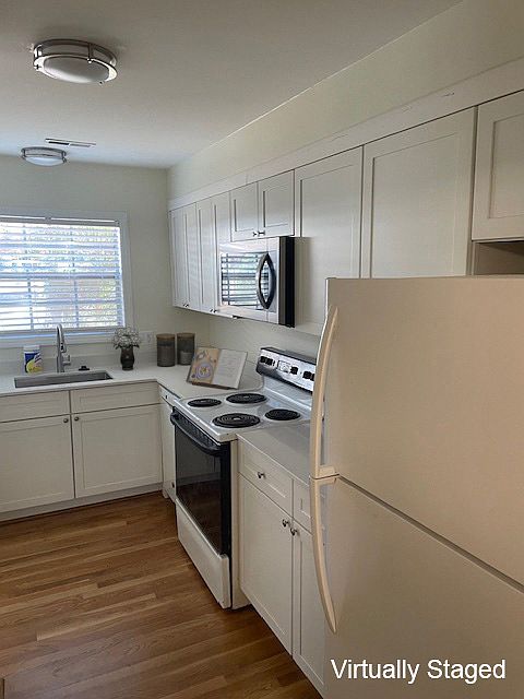 New kitchen cabinets with quartz counters & installed microwave.