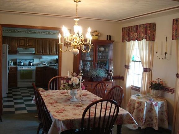 Stately formal dining room is accented by a tray ceiling & crown molding.