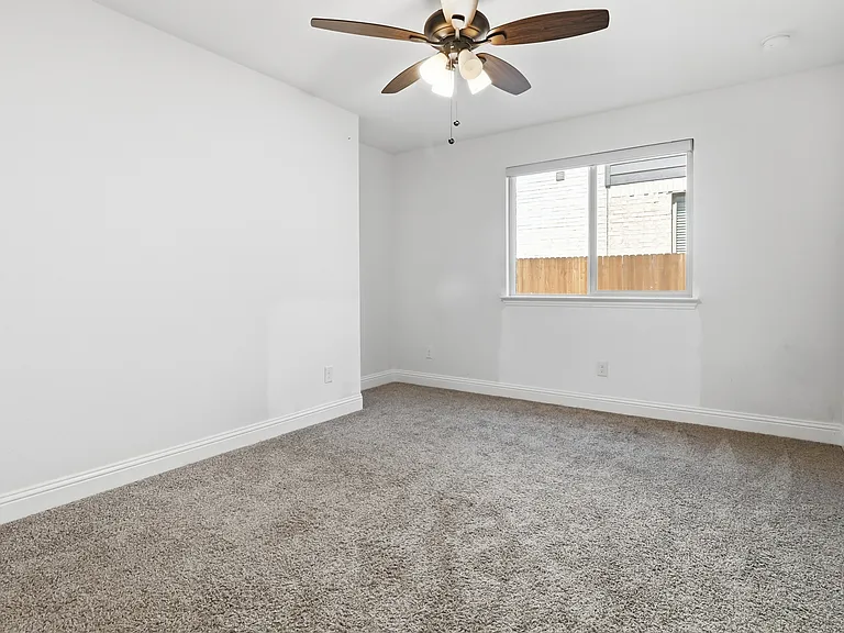 3rd Bedroom featuring neutral gray carpeting and white baseboards