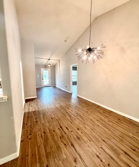 Living room facing front door & primary