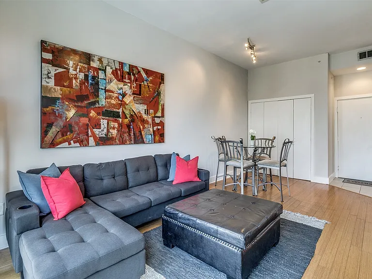 Open living area with large, bright windows and balcony.