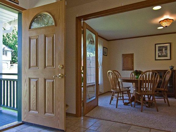 A view from the entry, through etched glass French doors, into the formal dining room.
