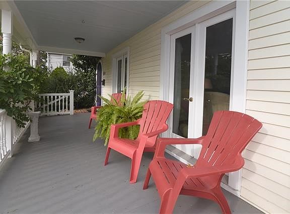 Charming front porch with Dual entrance into home as well as French doors leading into living room.