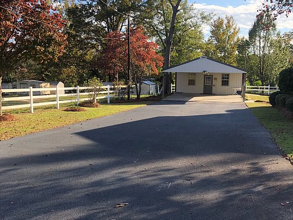 Asphalt drive to Carport/she